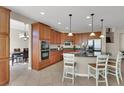 Beautiful kitchen with wood cabinets, stainless steel appliances, and a breakfast bar at 3925 Kettle Falls Ave, North Las Vegas, NV 89085
