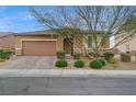 Inviting single-story home with a two-car garage, stone accents, and well-maintained landscaping, offering an attractive facade at 3937 Ravens Ct, North Las Vegas, NV 89032