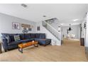 Open living room with comfortable seating, stylish decor, and staircase at 3950 S Sandhill Rd # 132, Las Vegas, NV 89121