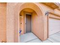 Inviting front entryway featuring a charming archway and carriage-style lighting at 4909 Lavaliere Ave, Las Vegas, NV 89139