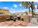 Cozy outdoor patio with brick walls, lounge chairs and coffee table at 6429 Pronghorn Ridge Ave, Las Vegas, NV 89122
