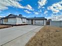 Single story home featuring a long driveway and lawn at 6489 Gunderson Blvd, Las Vegas, NV 89103