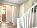 Hallway features wood look tile floors, white trim, and access to a bathroom at 6507 Dove Point Pl, Las Vegas, NV 89130