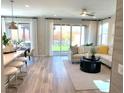 Open concept living room with sliding doors to the backyard and neutral décor at 6507 Dove Point Pl, Las Vegas, NV 89130