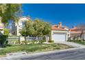 Lovely two-story stucco home with red tile roof, wrought iron fencing, and a two-car garage at 8200 Horseshoe Bend Ln, Las Vegas, NV 89113