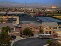 Beautiful aerial view shows community amenities with mountain backdrop during twilight at 827 Happy Sparrow Ave, Henderson, NV 89052