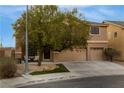 Charming two-story home with a three-car garage, mature tree, and covered porch at 827 Happy Sparrow Ave, Henderson, NV 89052
