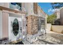 Close up of a white front door, on a two story home with stone accents and mature landscaping at 8988 Dusseldorf Way, Las Vegas, NV 89147