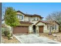 Attractive two-story house with a three car garage and easy to care for landscaping at 9160 Moose Country Pl, Las Vegas, NV 89178