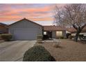 Charming single-story home featuring desert landscaping, a two-car garage, and a red tile roof at 1019 Amber Gate St, Henderson, NV 89002