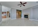 Spacious living room with a fireplace and marble floors, leading into other living areas at 10260 Hawks Wing St, Las Vegas, NV 89178