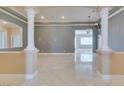 Elegant living space featuring stately columns, marble flooring, and neutral color palette at 10260 Hawks Wing St, Las Vegas, NV 89178