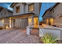 Beautiful two-story home with a paved driveway, landscaped yard, and a two-car garage at 122 Cabaletta Ln, Henderson, NV 89015