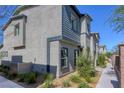 Townhome exterior with landscaping and walkway leading to entrance at 12728 Feathersong St, Henderson, NV 89044