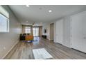 Bright living room with wood floors, recessed lighting, and sliding glass doors to the outside at 221 Mountain Cedar Ct, North Las Vegas, NV 89031