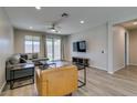 Comfortable living room featuring modern decor, a ceiling fan, and lots of natural light at 221 Mountain Cedar Ct, North Las Vegas, NV 89031