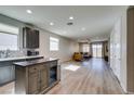 Open-concept kitchen and living area with modern finishes and lots of natural light at 221 Mountain Cedar Ct, North Las Vegas, NV 89031