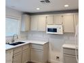 Bright kitchen featuring white cabinets, sleek countertops, and modern appliances at 2431 Lilac Cove St, Las Vegas, NV 89135