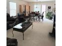 Cozy living room features a comfortable sofa, dining area with natural light, and views of the outdoor space at 2431 Lilac Cove St, Las Vegas, NV 89135