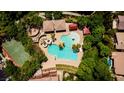 Aerial view of a community pool featuring a waterslide, splash pad, and basketball court at 2431 Lilac Cove St, Las Vegas, NV 89135