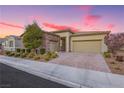 Lovely single-story home showcasing a well-maintained yard, brick driveway, and a two-car garage at 2450 Amatrice St, Henderson, NV 89044