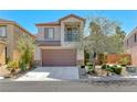 Two-story home with stone accents, a balcony, and a well-manicured front yard at 2528 Flodden St, Henderson, NV 89044