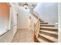Grand foyer featuring tile flooring, a staircase, and a soaring ceiling at 2528 Flodden St, Henderson, NV 89044