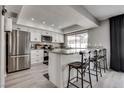 Modern kitchen featuring stainless steel appliances, a breakfast bar, and lots of natural light at 2532 Whippoorwill Ln, Las Vegas, NV 89121