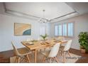 Staged dining room featuring a modern light fixture and a large window with wood shutters at 2916 W Oakey Blvd, Las Vegas, NV 89102