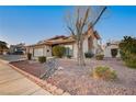 Charming two-story home features a two car garage, brick chimney, desert landscaping, and shuttered windows at 2916 W Oakey Blvd, Las Vegas, NV 89102