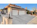 Spacious three-car garage with an expansive driveway and partial view of the front exterior at 2916 W Oakey Blvd, Las Vegas, NV 89102