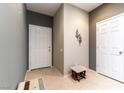 Bright entryway featuring neutral tiling, gray walls, and a charming accent stool at 2970 Strathspey Ct, Henderson, NV 89044