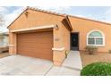 Inviting front of home with two-car garage, xeriscaping and covered entry at 2970 Strathspey Ct, Henderson, NV 89044