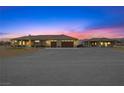 Sprawling ranch style home featuring a circular drive, attached garage, and mature landscaping at 3600 E Bridger St, Pahrump, NV 89061