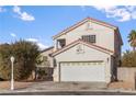 Charming two-story home with a well-manicured lawn, a two-car garage, and a red tile roof at 3632 Julia Waldene Ct, Las Vegas, NV 89129