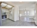 Open concept living space features modern gray flooring and a bright kitchen space at 4083 Nook Way # D, Las Vegas, NV 89103