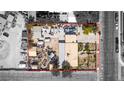 Aerial view of property showing clutter, main house, garages, sheds, RV parking area, and yard at 4300 Thom Blvd, Las Vegas, NV 89130