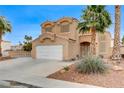Two-story home with desert landscaping, driveway, and a two-car garage at 4431 Palm Mesa Dr, Las Vegas, NV 89120