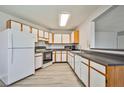 Bright kitchen featuring white cabinets, laminate countertops and light wood grain flooring at 5121 Pioneer Ave # 204, Las Vegas, NV 89146