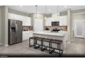 Modern kitchen featuring white cabinets, stainless steel appliances, and a center island with bar seating at 5180 Hisopo St # Lot 24, Las Vegas, NV 89122