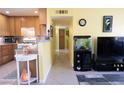 Bright living room featuring a breakfast bar, and neutral tile flooring throughout at 5206 Mandalay Springs Dr # 204, Las Vegas, NV 89120