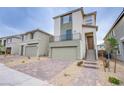 Contemporary two-story home features a two-car garage, desert landscaping, and a second-floor balcony at 5748 Avondale Rise Way, Las Vegas, NV 89141