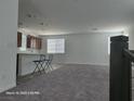 Inviting living space adjacent to the kitchen, featuring modern seating and ample room for relaxation and entertainment at 5748 Avondale Rise Way, Las Vegas, NV 89141
