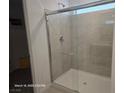 Modern bathroom showcasing a tiled shower enclosure with glass door and chrome fixtures for a sleek, clean aesthetic at 5748 Avondale Rise Way, Las Vegas, NV 89141