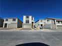 Street view of modern homes with neutral paint, each featuring a two-car garage and contemporary design elements at 5748 Avondale Rise Way, Las Vegas, NV 89141