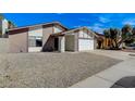 Charming single-story home with a two-car garage and low maintenance desert landscaping at 6782 Bonillo Dr, Las Vegas, NV 89103