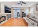 Bright living room featuring a cozy fireplace, wood flooring, and comfortable gray sofa at 7904 Mountain Point Ave, Las Vegas, NV 89131