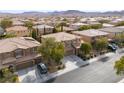A neighborhood view of two-story homes featuring a three-car garage, neutral color scheme, and drought-tolerant landscaping at 8425 Cambrils Ave, Las Vegas, NV 89178