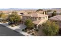 Suburban two-story home features a three-car garage, neutral color scheme, and drought-tolerant landscaping at 8425 Cambrils Ave, Las Vegas, NV 89178