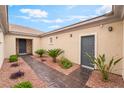 Enclosed courtyard with desert landscaping and private entrances to the residence at 8506 River Ridge Dr, Las Vegas, NV 89131